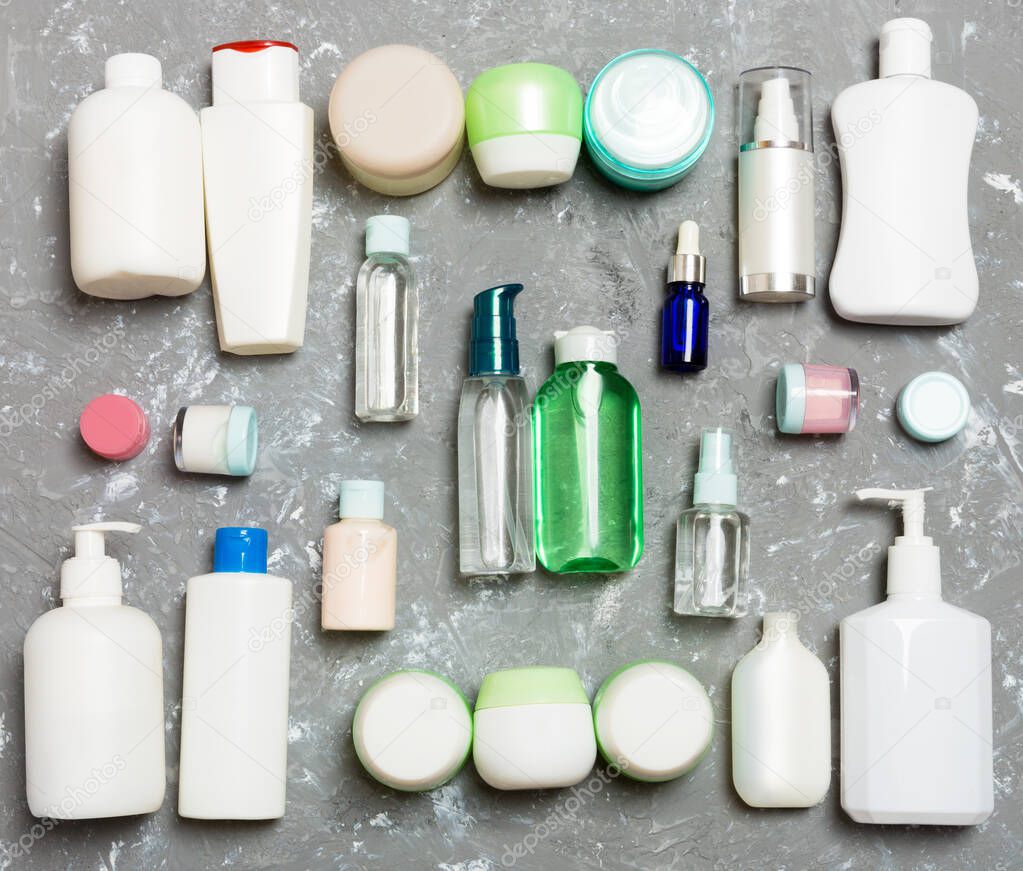 Group of plastic bodycare bottle Flat lay composition with cosmetic products on green background empty space for you design. Set of White Cosmetic containers, top view with copy space.