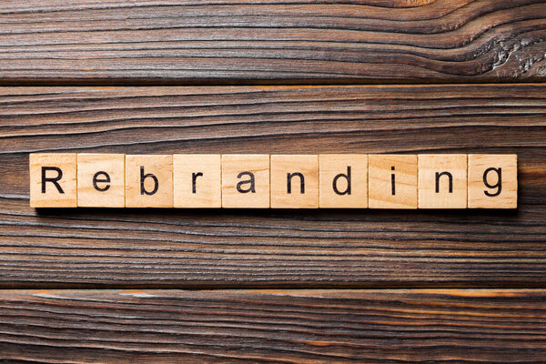rebranding word written on wood block. rebranding text on table, concept.