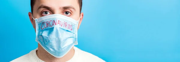 Portrait Young Sick Man Medical Mask Coronavirus Ncov Word Blue — Stock Photo, Image