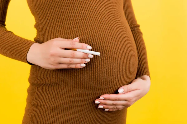 Pregnant woman breaks cigarette in half, says no to smoking Stock Photo by  ©SIphotography 51627555