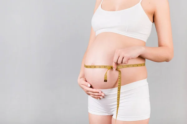 Cropped Image Pregnant Woman White Underwear Measuring Her Growing Abdomen — Stock Photo, Image