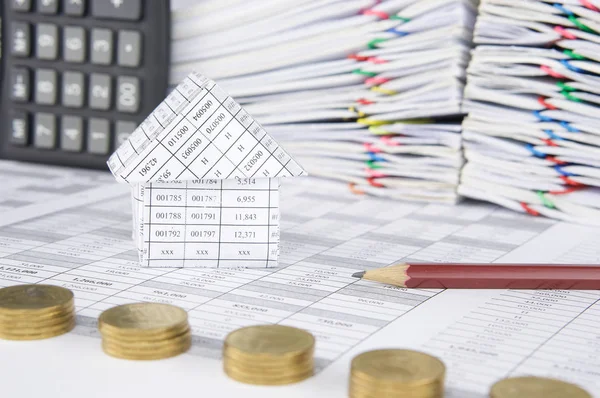 House and pencil have blur pile gold coins as foreground — Stock Photo, Image