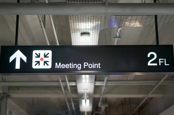Meeting point information board sign at international airport terminal