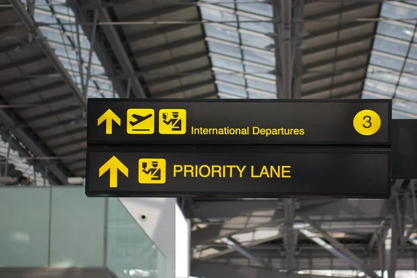 Departure and priority lane board sign at international airport