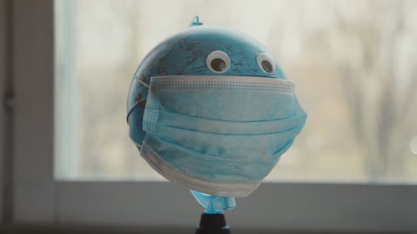 Globe in protective medical mask — Stock Video