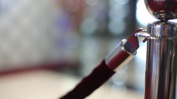 Closeup of women hand opening red velvet rope — Stock Video