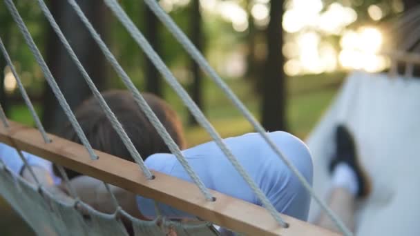 Portrait of an attractive man relax in hammock. Back view. — Stock Video