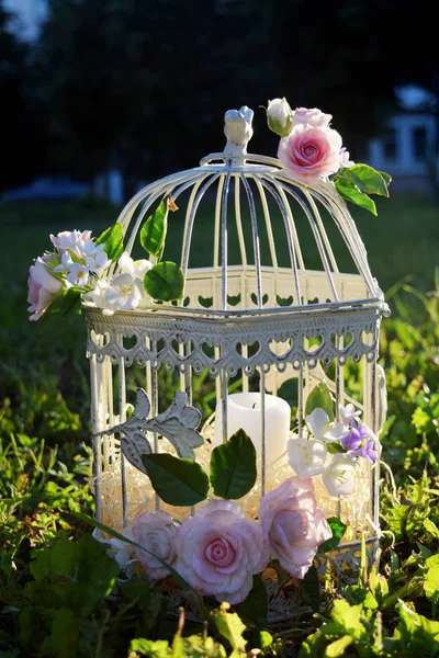 Bird cage with spring blossom flowers. Wedding decorations. Royalty Free Stock Photos