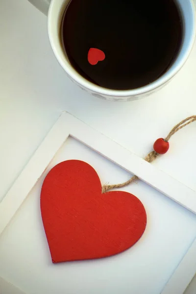 Kopp kärlek, kaffe med rött hjärta. Rött hjärta på ett rep i träram. Alla hjärtans dag. Morgon. Den 14 februari. — Stockfoto