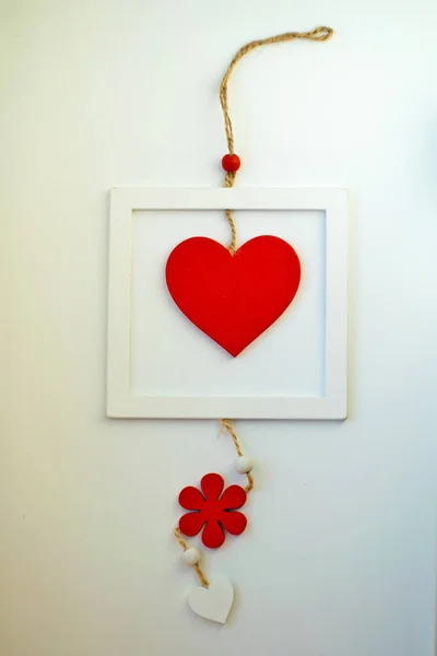 Red heart on a rope in the wooden frame. Valentine's day. — Stock Photo, Image