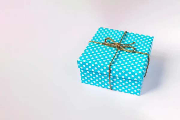 Pembe arka planda hassas mavi kutu. El sanatları yayı ile bayram hediyesi. — Stok fotoğraf