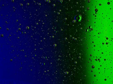 bubbles blowing up into a tough substance with a colored background