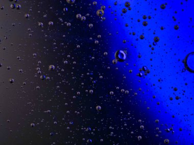 bubbles blowing up into a tough substance with a colored background