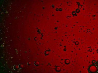 bubbles blowing up into a tough substance with a colored background
