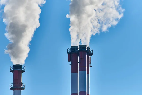 industrial factory, smoke from chimneys and blue sky