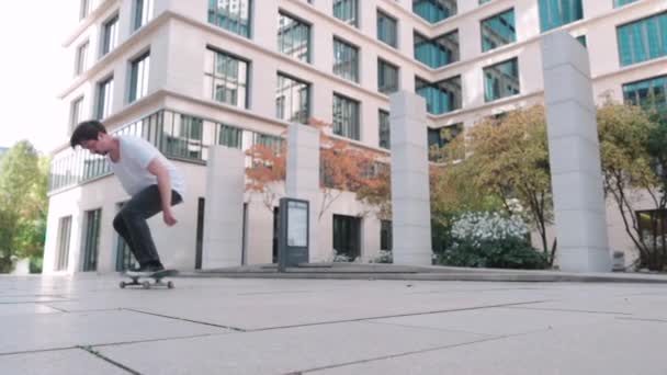 Skateboarder Doing Flip Trick Super Slow Motion Business Buildings 스톡 푸티지