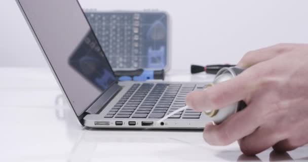 Service Worker Cleaning Laptop Connection Plugs Compressed Air White Walled — Stock Video