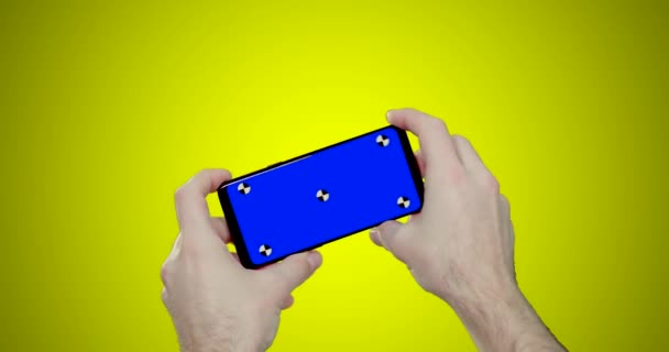 Man Hands Holding Smartphone Horizontal Playing Race Game Blue Chroma — Stock Video