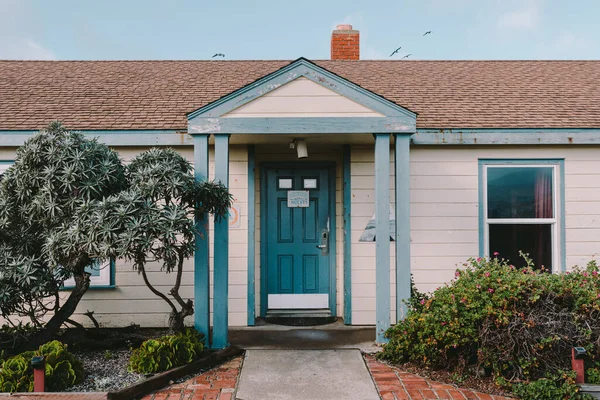 Pescadero, California / United States - December 2018: HI Pigeon Point Lighthouse Hostel front door. Nice blue and white house with green plants in front of the house