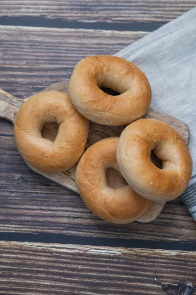 Bagels on a wooden table. Top view. Vertical picture. — Stock Photo, Image