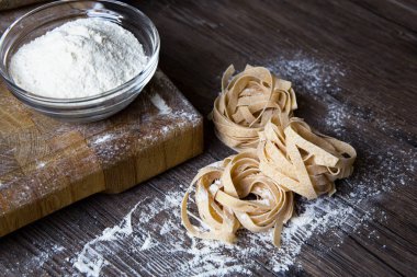 Raw homemade pasta and ingredients for pasta clipart