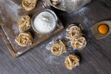 Raw homemade pasta and ingredients for pasta clipart