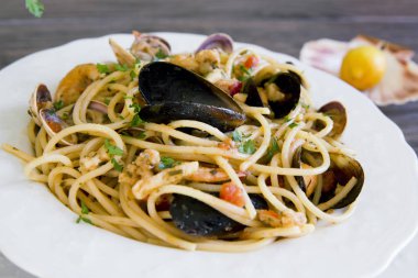 Deniz ürünleri ahşap backgrou üzerinde beyaz seramik tabak spagetti