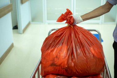 Infectious waste must be disposed of in the trash bag and red in hospitals. biohazard bag for infectious waste clipart