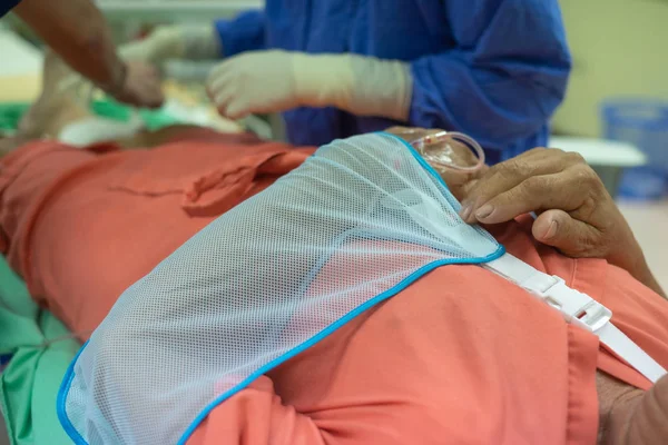 Patient with broken arm in sling in hospital