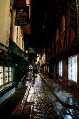 York, North Yorkshire / Uk - 19 Şubat 2020 'de York, Kuzey Yorkshire' daki Shambles bölgesinde binaların ve mimarinin görüntüsü. Kimliği belirsiz iki kişi.