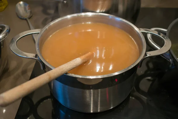 Soup cooking in a pan on an electric hob for Christmas dinner