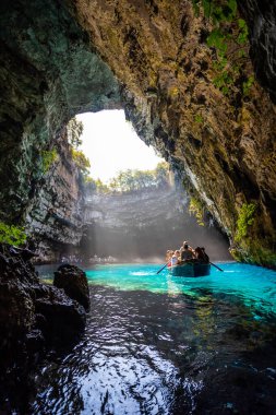 KEFALONIA, GREECE - SEPTEMBER, 13:Melissani Lake Cave: Tourist boat on the lake in Melissani Cave, Kefalonia Island, Greece on September 13, 2019, clipart