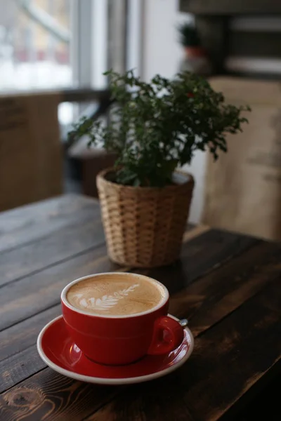 Μια κούπα μεγάλη καφέ κόκκινο σε ένα ξύλινο τραπέζι. — Φωτογραφία Αρχείου