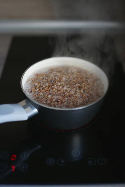 Boiling Buckwheat Saucepan Electric Black Stove Glossy Surface — Stock Photo, Image