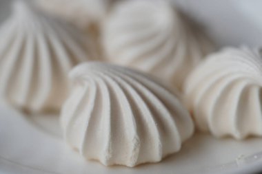 Beyaz plaka arkaplanındaki beyaz şekerleme görüntüsünü kapat