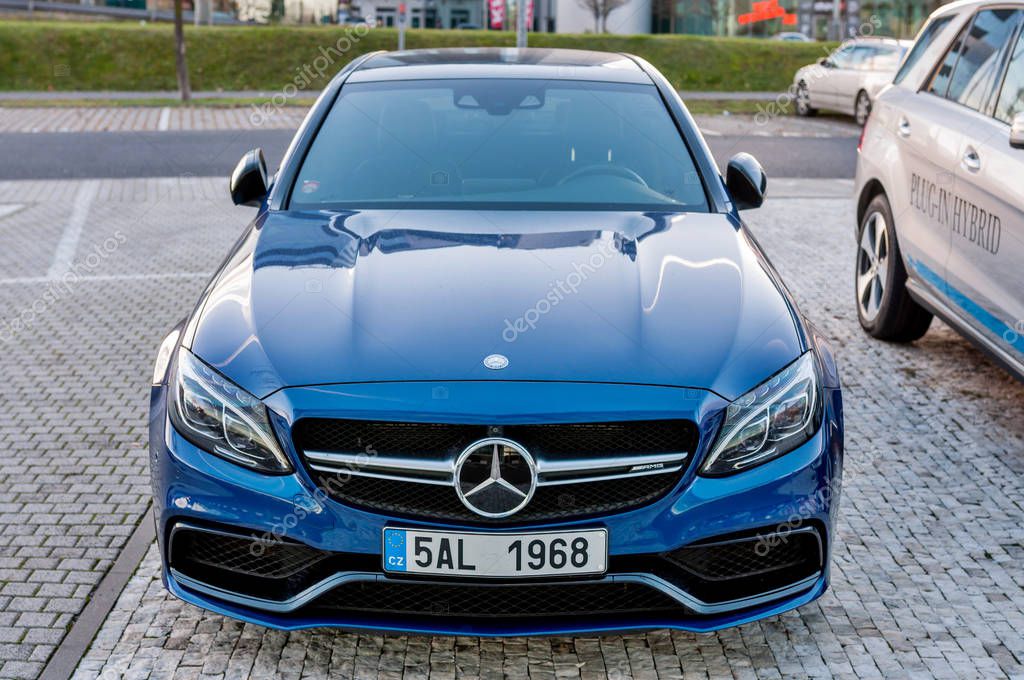 PRAGUE, THE CZECH REP., NOVEMBER 27, 2016: Closeup of new luxury car Mercedes-Benz c-class C63, parking in front of car store. Detail front view of cars