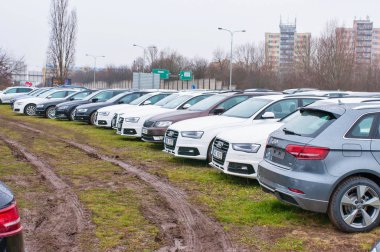Audi araba satıcısı Audi önünde park etmiş.