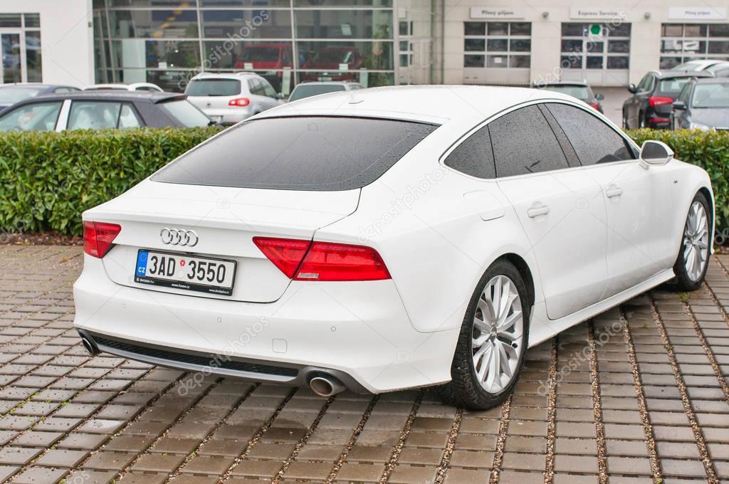 PRAGUE, THE CZECH REPUBLIC, 18.12.2016 - Closeup of new white car Audi A5 TDI quattro parking in front of car dealership Audi
