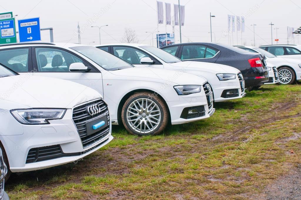 PRAGUE, THE CZECH REPUBLIC, 18.12.2016 - Audi cars parked in row in front of official car dealer Audi in Prague. Front view of white and black cars in row