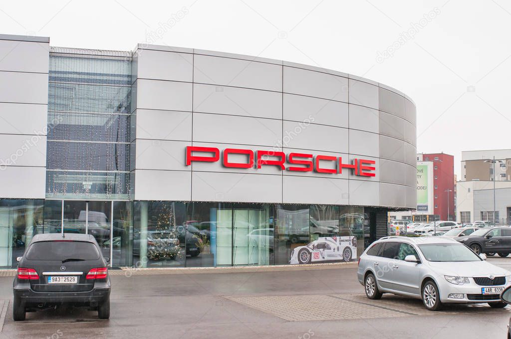 18.12.2016, Prague, Czech Republic: Closeup of Porsche cars in front of car dealership Porsche. Luxury fast and expensive cars standing in row.