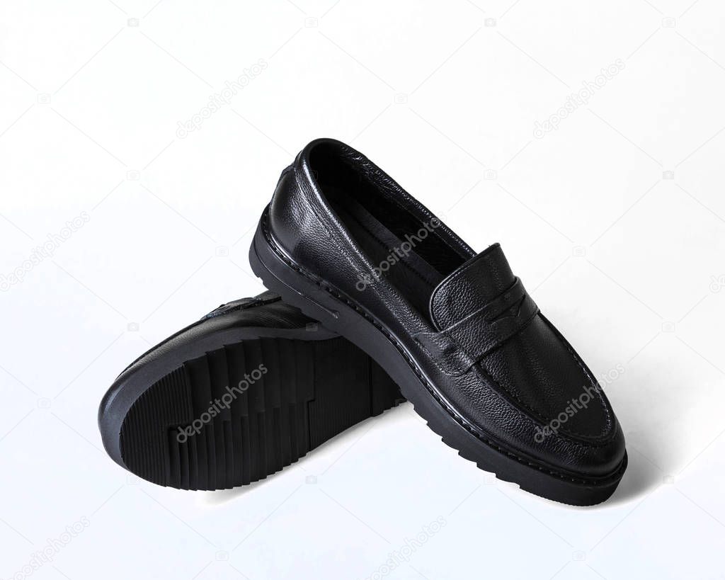 Black leather male shoes, white background.