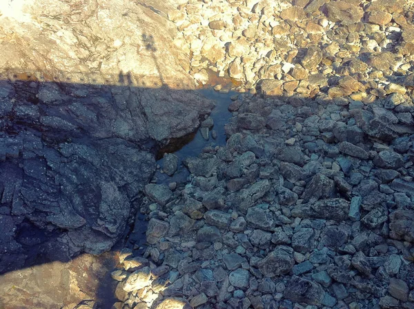 Stone ground in a dried river mouth on picture.