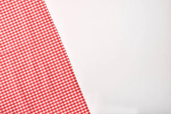 Red and white checkered fabric on white table top — Stock Photo, Image