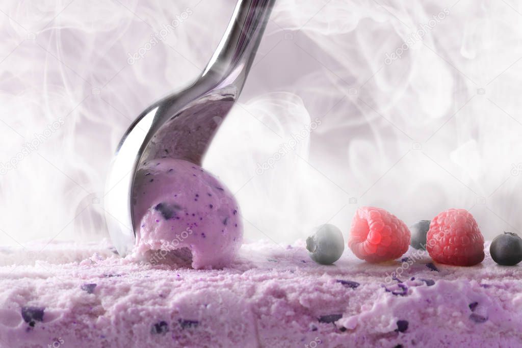 Making a berry ice cream with scoop front view