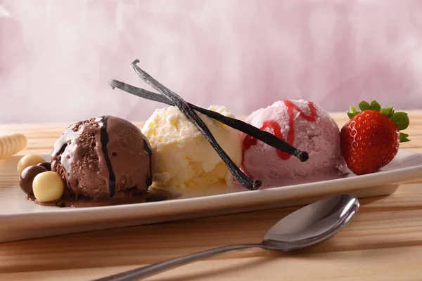 Three balls ice cream different tastes on wood table front