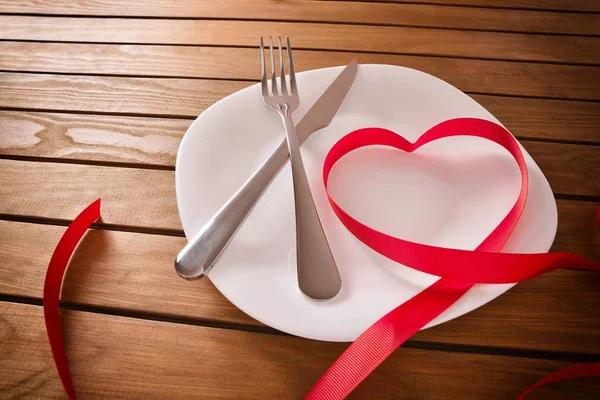 Table decorated with ribbon forming a heart elevated view — Stock Photo, Image