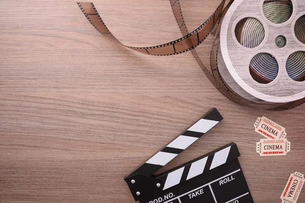 Equipment and elements of cinema on wooden table. Concept of watching movies. Horizontal composition. Top view.