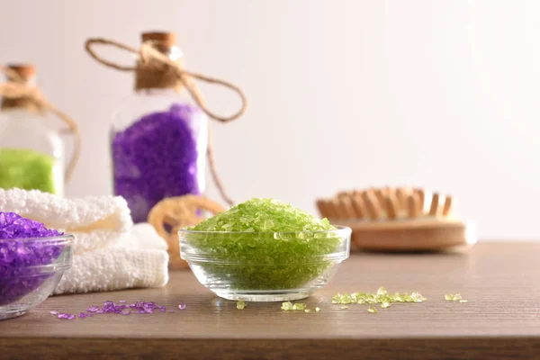 Bath salts and massage brush on wooden table front — 스톡 사진