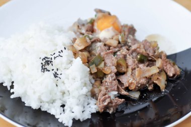 Kızarmış eti sebze ve pirinç yemeğiyle karıştır.