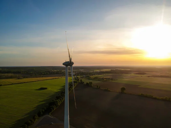 Wind turbine at sunset. Energy from wind.